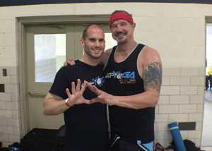 Adam Bockler and Diamond Dallas Page pose at a DDPYoga event in LaSalle, IL