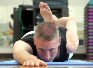 A military person stretches in a yoga pose