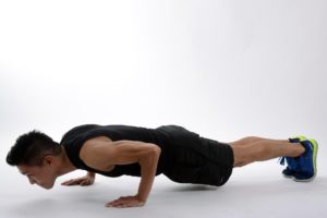 From a high plank, lower your body and hold it 3 inches off the ground. 